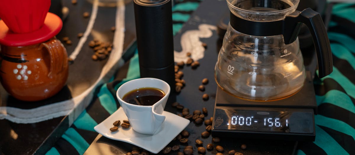 A complete coffee brewing setup featuring a precision scale and fresh coffee beans.